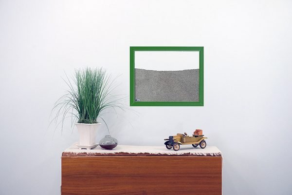 green painted wood frame ant farm hanging on wall